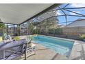 Relaxing screened-in pool area with comfortable seating and tropical plants at 1010 Chance Cv, Oviedo, FL 32765