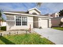 Inviting single-story home exterior with a well-maintained lawn and attached garage at 111 Windy Dune Ct, Kissimmee, FL 34743