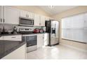Modern kitchen with white cabinets, stainless steel appliances, and ample counter space at 111 Windy Dune Ct, Kissimmee, FL 34743
