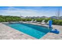 Relaxing pool area with a spa, lounge chairs, and a basketball hoop at 159 Golden Noble St, Kissimmee, FL 34747