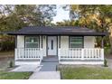 Charming one-story home with white exterior and a small front yard at 3149 W Washington St, Orlando, FL 32805