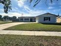 Newly renovated home with a large yard and updated landscaping at 3522 E Kaley Ave, Orlando, FL 32806
