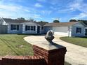 Newly renovated home with a large driveway and brick pillars at 3522 E Kaley Ave, Orlando, FL 32806