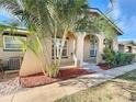 Tan house with arched entryway and tropical landscaping at 505 Polaris Loop # 107, Casselberry, FL 32707