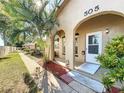 Front entrance with walkway and tropical landscaping at 505 Polaris Loop # 107, Casselberry, FL 32707