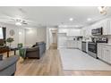 Open concept kitchen with white cabinets and stainless steel appliances at 5851 Edouard St, Oviedo, FL 32765