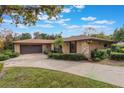 Exterior view of a single-story home with an attached one-car garage at 1098 Park Dr, Casselberry, FL 32707