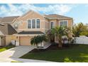 Two-story house with tan exterior, three-car garage, and palm trees at 1515 Cedar Lake Dr, Orlando, FL 32824