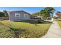 Gray house with front yard, sidewalk, and street view at 2310 Fairgren Ave, Deltona, FL 32738