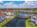 Aerial view of waterfront community with lake, bridge, and numerous homes at 2504 Woodgate Blvd # 107, Orlando, FL 32822