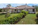 Single-story home with covered porch and lush landscaping at 7138 Oil Well Rd, Clermont, FL 34714