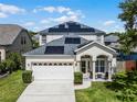 Two-story house with solar panels and a landscaped yard at 842 Cherry Valley Way, Orlando, FL 32828