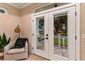 Living room with French doors opening to a patio at 12133 Grand Oak Ln, Oxford, FL 34484