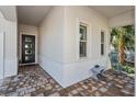 Front porch with a rocking chair and brick pavers at 15730 Cutter Sail Pl, Winter Garden, FL 34787