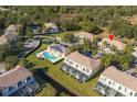 Aerial view showing home's location in community with pool and playground at 17417 Placidity Ave, Clermont, FL 34714