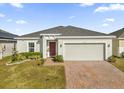One-story home with two-car garage and landscaped front yard at 236 Denali St, Haines City, FL 33844
