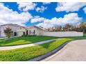 House exterior showing a landscaped lawn, driveway, and a curved sidewalk at 441 Tallow Wood Cir, Debary, FL 32713