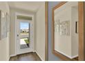 Bright entryway with white door and wood-look floors at 5548 Hayloft Dr, Apopka, FL 32712