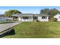 Newly renovated home with a spacious lawn and driveway at 2588 Sun Acres Blvd, Auburndale, FL 33823