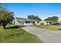 Newly renovated home with a spacious lawn and driveway at 2588 Sun Acres Blvd, Auburndale, FL 33823