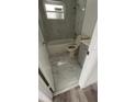 Updated bathroom with white vanity, toilet, and marble-look flooring at 26221 Se 159Th Ln, Umatilla, FL 32784