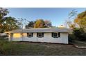 Newly renovated white house with gray roof and landscaping at 26221 Se 159Th Ln, Umatilla, FL 32784
