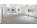 Spacious living room featuring light gray carpeting and lots of natural light at 3334 Mount Tabor Rd, Lakeland, FL 33810