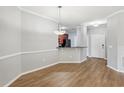Bright dining area with hardwood floors and kitchen access at 3725 Conroy Rd # 2131, Orlando, FL 32839