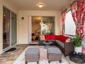 L-shaped sectional and ottomans in a screened-in patio at 8933 Amelia Downs Trl, Kissimmee, FL 34747