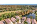 Community view with houses, pond, and golf course at 944 Torrey Pine Dr, Winter Springs, FL 32708