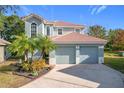 Two-story house with two-car garage and landscaping at 944 Torrey Pine Dr, Winter Springs, FL 32708