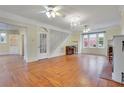 Spacious living room featuring hardwood floors, a fireplace, and built-in shelving at 1217 Magnolia Ave, Sanford, FL 32771