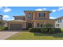 Charming two-story home with a welcoming front entrance and landscaped yard at 2731 Flintlock Ave, Clermont, FL 34711