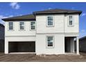 Two-story house with light beige siding, attached garage, and dark brown roof at 5739 Cattle Ranch Dr, Saint Cloud, FL 34771