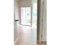 Bright living room with sliding glass doors and hardwood floors at 2015 Erving Cir # 108, Ocoee, FL 34761
