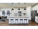 Modern kitchen with white cabinets, island, and stainless steel appliances at 3022 Norcott Dr, Davenport, FL 33837