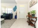 Welcoming foyer with tiled floor, stylish decor, and access to living area at 328 Conway Ave, Saint Cloud, FL 34771