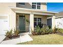Covered front porch with seating area, grill, and lush landscaping at 328 Conway Ave, Saint Cloud, FL 34771