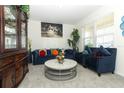 Cozy living area with plush blue furniture, decorative accents, and large windows at 328 Conway Ave, Saint Cloud, FL 34771