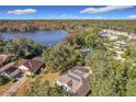 Aerial view of house near lake and other homes at 936 Oakpoint Cir, Apopka, FL 32712