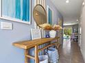 Entryway with console table, mirror, and artwork in a light and airy space at 1206 Balsam Dr, Davenport, FL 33837