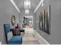 Elegant hallway with tile flooring and modern artwork at 1239 Radiant St, Reunion, FL 34747