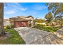 Long driveway leading to a two-car garage and the front entrance of the home at 1984 Westpointe Cir, Orlando, FL 32835