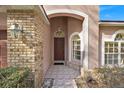 Welcoming front entry with a covered porch, brick accents, and decorative tiled pathway at 1984 Westpointe Cir, Orlando, FL 32835