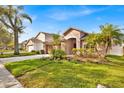 Inviting curb appeal with a lush green lawn, mature trees, and a well-maintained exterior at 1984 Westpointe Cir, Orlando, FL 32835