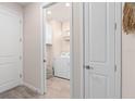 Bright laundry room with washer, dryer, and cabinets at 2326 Daisy Tree Rd, St Cloud, FL 34771