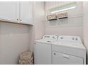White laundry appliances and ample storage at 2326 Daisy Tree Rd, St Cloud, FL 34771