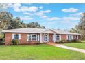 Newly renovated brick house with updated windows and landscaping at 3805 N Lake Orlando Pkwy, Orlando, FL 32808