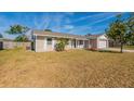 Side view of a single-story home with a fenced backyard and AC unit at 4901 Leprechaun Way, Orlando, FL 32808