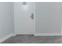White door with gray walls and wood-look flooring at 151 E Washington St # 201, Orlando, FL 32801